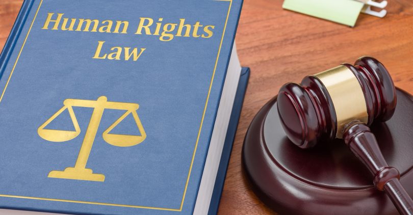 A law book with a gavel - Human Rights law